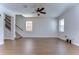 Bright and airy living room with hardwood floors, natural light, access to stairs, and an open layout at 11117 Abaco Island Ave, Riverview, FL 33579