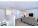 Loft area with neutral carpet, a comfortable couch, and access to multiple rooms at 11117 Abaco Island Ave, Riverview, FL 33579