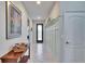 Well-lit hallway featuring stylish wainscoting detail, a decorative shelf, and an elegant entryway at 16313 Treasure Point Dr, Wimauma, FL 33598