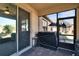 Screened patio featuring brick flooring, outdoor seating, and a sliding glass door to the home's interior at 16313 Treasure Point Dr, Wimauma, FL 33598