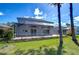 Backyard featuring a screened lanai and mature trees on a lush lawn at 18126 Kara Ct, Tampa, FL 33647