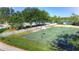 Outdoor community basketball court with trees and nearby community pool on a sunny day at 18126 Kara Ct, Tampa, FL 33647
