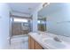 Bathroom with double sinks, tiled shower with glass door, and large mirror at 18126 Kara Ct, Tampa, FL 33647