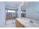 Bathroom with double sinks, tiled shower with glass door, and large mirror at 18126 Kara Ct, Tampa, FL 33647