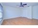 Bright bedroom featuring wood floors, ceiling fan, window with blinds, and a closet at 18126 Kara Ct, Tampa, FL 33647