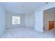 Bright bedroom with carpeting, large window with natural light, and a doorway to the upper floor at 18126 Kara Ct, Tampa, FL 33647