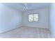 Inviting bedroom with neutral carpet, ceiling fan, and bright window at 18126 Kara Ct, Tampa, FL 33647