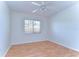 Cozy bedroom featuring wood floors, a ceiling fan, and a bright window at 18126 Kara Ct, Tampa, FL 33647