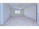 This carpeted bedroom features a ceiling fan and a window with blinds providing natural light at 18126 Kara Ct, Tampa, FL 33647