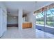 Dining area with tile floors and a sliding glass door out to the screened patio at 18126 Kara Ct, Tampa, FL 33647
