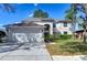 Spacious two-story home with a three-car garage and well-maintained lawn at 18126 Kara Ct, Tampa, FL 33647