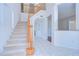 Foyer with carpeted stairs, light walls, and tile floors at 18126 Kara Ct, Tampa, FL 33647