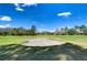 A manicured golf course is complete with a pristine sand bunker under a sunny, blue sky at 18126 Kara Ct, Tampa, FL 33647
