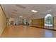 Bright hall with large windows, laminate floor, and mirrored wall, perfect for fitness or activities at 18126 Kara Ct, Tampa, FL 33647