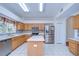 Bright kitchen featuring stainless steel appliances, an island, and tile flooring at 18126 Kara Ct, Tampa, FL 33647