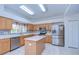 Spacious kitchen featuring stainless steel appliances, an island, and tile flooring at 18126 Kara Ct, Tampa, FL 33647