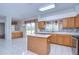 Bright eat-in kitchen with white tile floors, an island, stainless appliances, and a breakfast bar at 18126 Kara Ct, Tampa, FL 33647