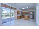 Open eat-in kitchen with wood cabinets and slider door to the screened lanai at 18126 Kara Ct, Tampa, FL 33647