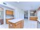 Eat-in kitchen featuring tile floors, bright white walls, and a center island at 18126 Kara Ct, Tampa, FL 33647