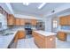 Bright kitchen with stainless steel appliances, center island, and light wood cabinets at 18126 Kara Ct, Tampa, FL 33647