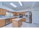 Bright eat-in kitchen with light wood cabinets and stainless steel appliances at 18126 Kara Ct, Tampa, FL 33647