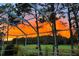 Enclosed lanai with a beautiful sunset view, creating a perfect space for relaxation and outdoor dining at 18126 Kara Ct, Tampa, FL 33647
