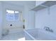 Clean laundry room with a utility sink, a storage shelf, and a window for natural light at 18126 Kara Ct, Tampa, FL 33647