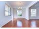 Living room featuring hardwood floors, bright natural lighting, and a chandelier at 18126 Kara Ct, Tampa, FL 33647