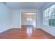 Open living room showcasing hardwood floors, large windows, and an archway leading to other living spaces at 18126 Kara Ct, Tampa, FL 33647