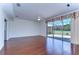 Spacious living room with hardwood floors and sliding glass doors leading to a screened patio at 18126 Kara Ct, Tampa, FL 33647
