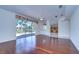 Bright living room with hardwood floors and sliding glass doors leading to a screened patio at 18126 Kara Ct, Tampa, FL 33647