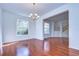 Bright living room featuring hardwood floors, large windows, chandelier, and an open archway to other rooms at 18126 Kara Ct, Tampa, FL 33647