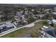 Aerial view of a residential area with mature trees and a variety of homes at 1875 Oak Branch Dr, Sarasota, FL 34232