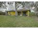 Spacious yard boasts mature trees, firepit, and outdoor enjoyment at 1875 Oak Branch Dr, Sarasota, FL 34232