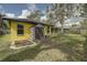 A lush backyard includes a storage shed and raised planting beds at 1875 Oak Branch Dr, Sarasota, FL 34232