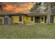 A spacious backyard with a firepit, mature trees, and plenty of room to relax and entertain at 1875 Oak Branch Dr, Sarasota, FL 34232