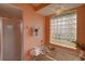 Bathroom featuring a soaking tub with a glass block window and glass shower at 1875 Oak Branch Dr, Sarasota, FL 34232