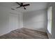 Bedroom featuring laminate floors, neutral walls, fan, closet and a window at 1875 Oak Branch Dr, Sarasota, FL 34232