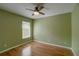 Bedroom featuring laminate floors, neutral walls, fan, and a window at 1875 Oak Branch Dr, Sarasota, FL 34232
