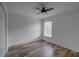 Bedroom featuring laminate floors, neutral walls, fan, and a window at 1875 Oak Branch Dr, Sarasota, FL 34232