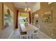 Dining room featuring a long white table set for six, with a view to a screened lanai at 1875 Oak Branch Dr, Sarasota, FL 34232