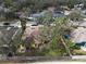 Aerial view of yellow home featuring mature trees and a fenced backyard at 1875 Oak Branch Dr, Sarasota, FL 34232