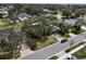 Aerial shot of a yellow home with mature trees and a well-kept lawn at 1875 Oak Branch Dr, Sarasota, FL 34232