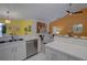 Open-concept kitchen boasts stainless steel appliances and an island, perfect for cooking and entertaining guests at 1875 Oak Branch Dr, Sarasota, FL 34232