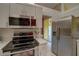 Well-equipped kitchen features stainless steel appliances, a microwave, and easy access to the outdoor patio at 1875 Oak Branch Dr, Sarasota, FL 34232