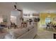 Open-concept living room and kitchen seamlessly connected, featuring a large couch and barstool seating at 1875 Oak Branch Dr, Sarasota, FL 34232