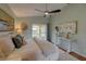 Bright main bedroom with wood floors, ceiling fan, and view to the outdoor patio at 1875 Oak Branch Dr, Sarasota, FL 34232