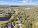 Aerial view overlooking the golf course, lake, surrounding community, and the home’s backyard at 1902 Sweet Bay Ct, Plant City, FL 33566
