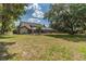 Sprawling backyard featuring lush greenery, a screened-in pool, and mature trees at 1902 Sweet Bay Ct, Plant City, FL 33566