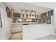 This in-home bar features a wine rack, storage, and mirrors at 1902 Sweet Bay Ct, Plant City, FL 33566